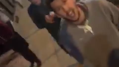 Guy blue shirt holding camera and friends screaming at it