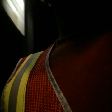 Subway train worker between two running trains