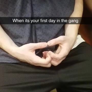 Guy in a blue shirt making symbols with hands