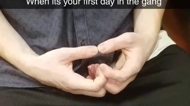 Guy in a blue shirt making symbols with hands