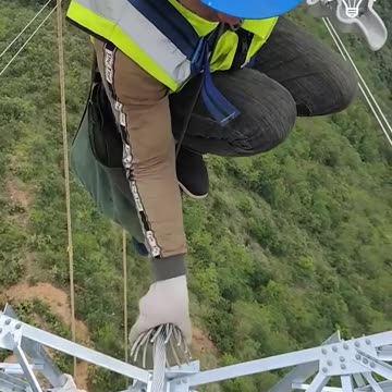 This electrician is equipped with safety tools while working at heights