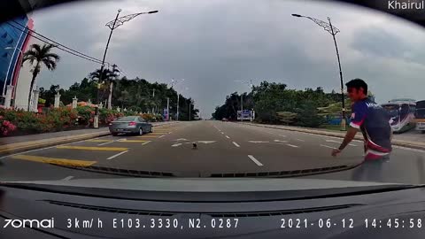 Man Rescues a Kitten Playing On Crowded Street