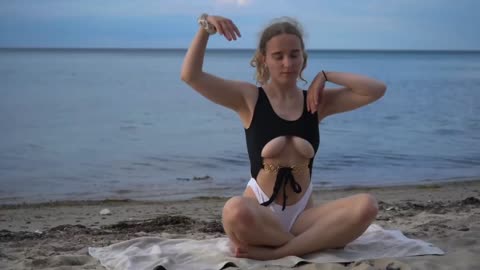 Yoga on the beach in a swimsuit