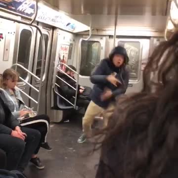 Blue hoodie guy dances and jumps in subway car