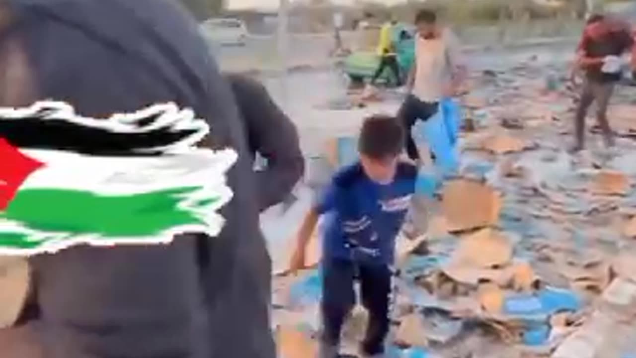 In light of the lack of drinking water, an aid truck capsizes in a street in Gaza