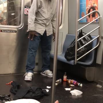 Man looking and talking to trash on floor