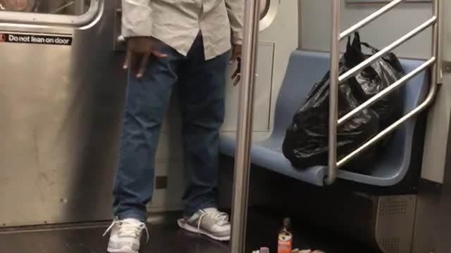 Man looking and talking to trash on floor