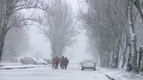 People running in the heavy snow