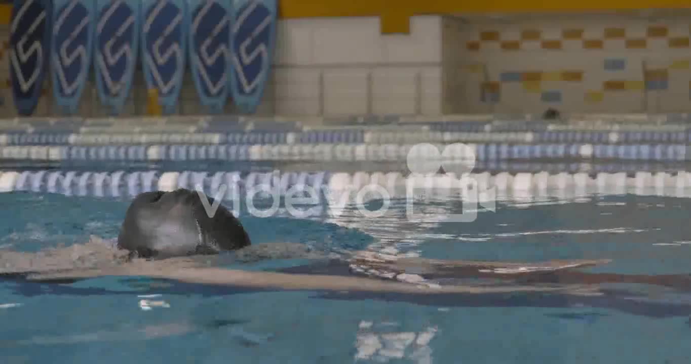 Close Up Of A Young Swimmer Girl Swimming Concentrated In The Indoor Pool