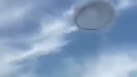 An enigmatic, ring-shaped UFO was spotted hovering in the clouds over Venezuela during the day