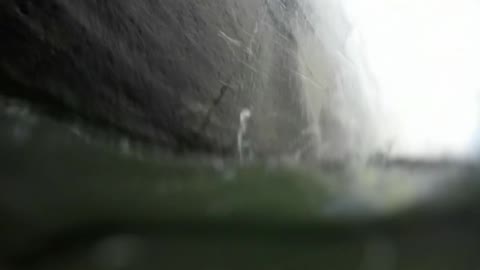 Two guys jump behind a waterfall one panics