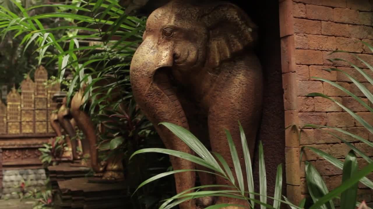 an elephant statue in an Asian-style park