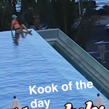 Girl in blue takes a picture of woman in red bathing suit
