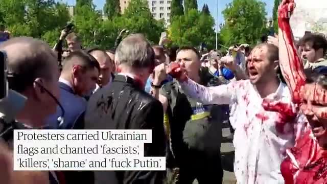 Russian ambassador doused in red by anti-war protesters in Poland