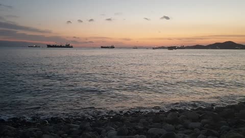 Gravel coast, sea and sunset