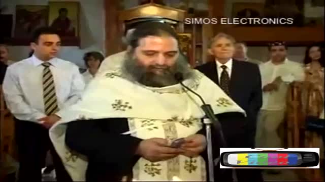 Priest reaches to his pocked to read a text message while speaking