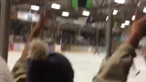 Hockey player runs into glass and knocks over tower of stacked cups