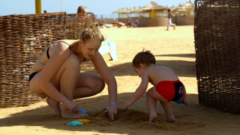 Family playing on the beach during a vacation