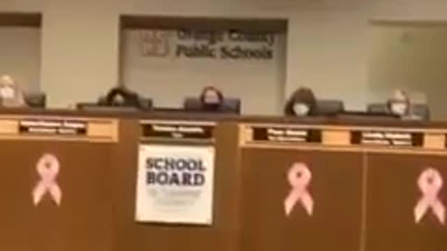 A journalist reads porn material books from the school's library at a Florida School Board Meeting