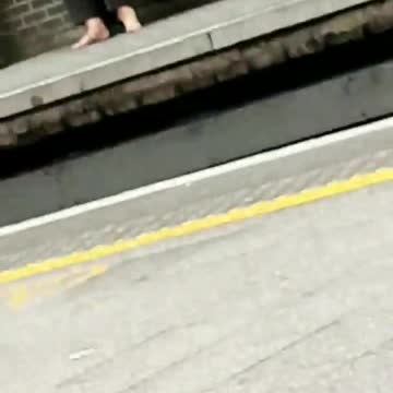Barefoot woman waiting for train