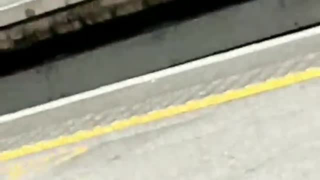 Barefoot woman waiting for train