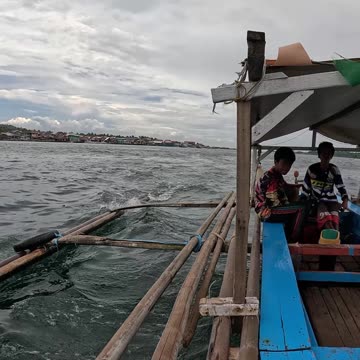 A traditional Bangka, motorized outrigger canoe ride from Malamawi Island to Isabela City Port