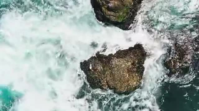 Birds Eye View of Crashing Waves on the Rock