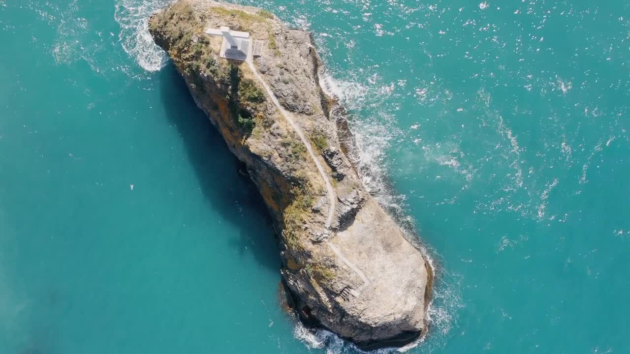 Bird’s eye view of cross on a coastal rock