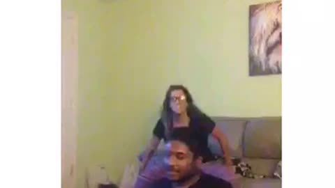 Two friends are dancing and one guy slams head on sofa