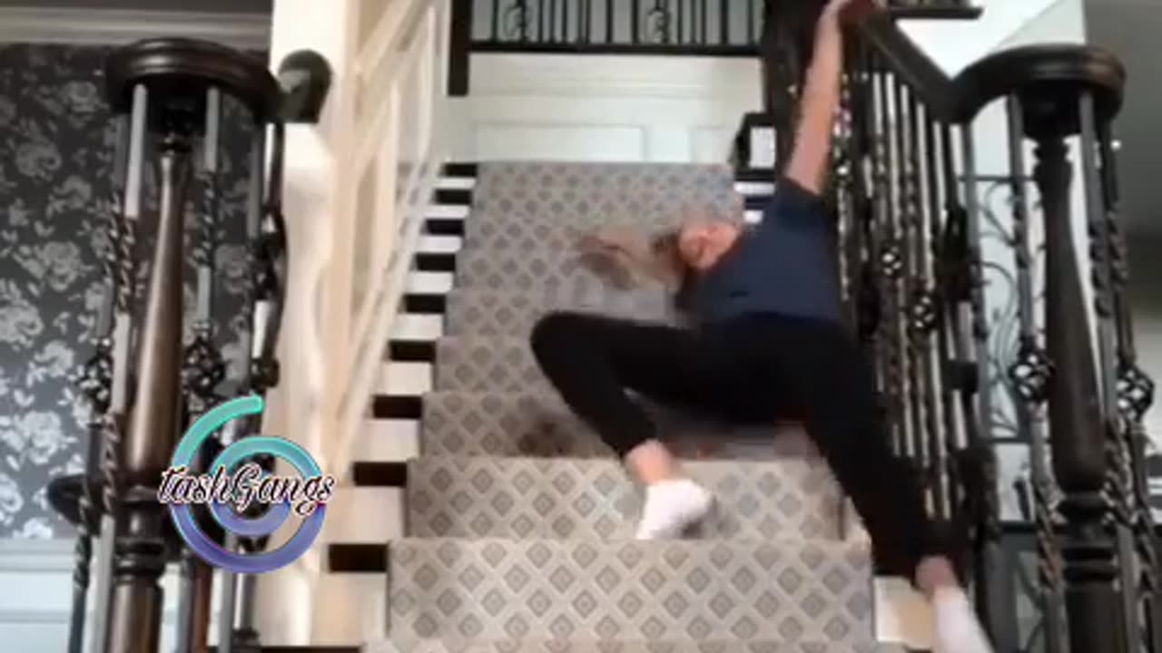 girl filming stupid tic tok clip slips down stairs.