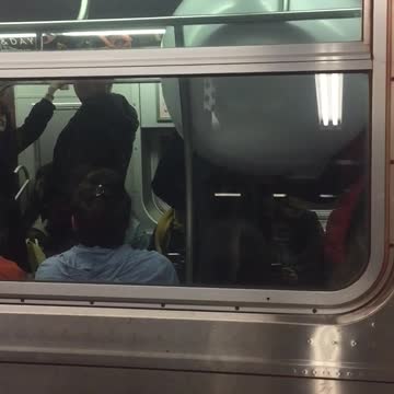 Outside of subway train person inside with giant white bowl