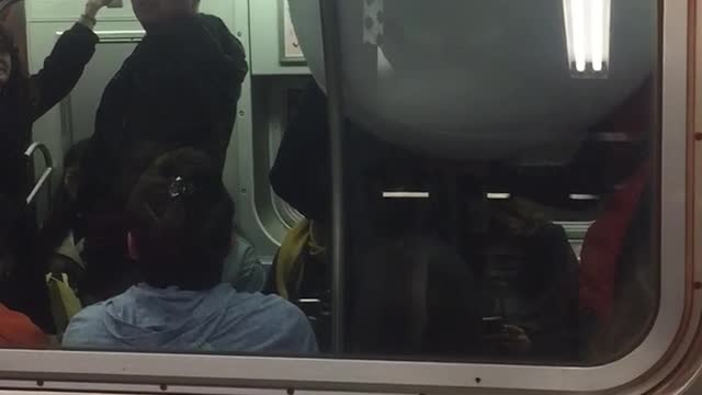 Outside of subway train person inside with giant white bowl