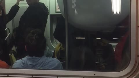 Outside of subway train person inside with giant white bowl
