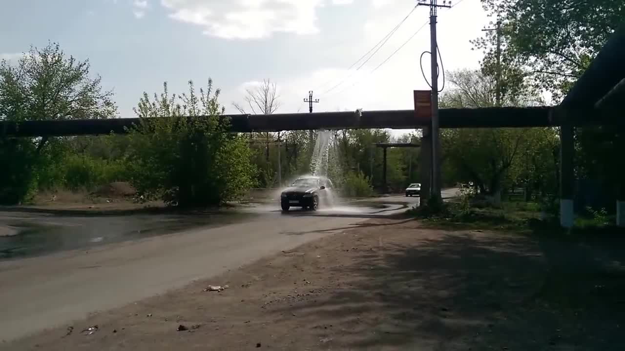 Drivers Use Busted Water Pipeline as Car Wash