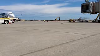 Frontier Airlines arriving at airport gate