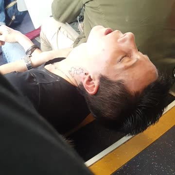 Black shirt woman passes out falls asleep on bus