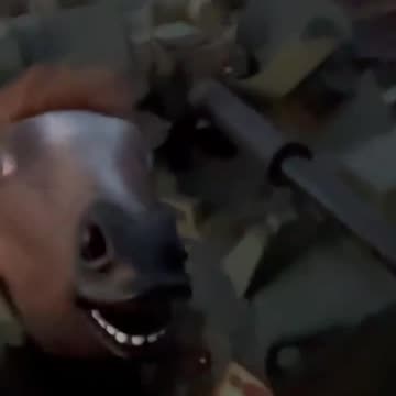 A Russian soldier on top of a BTR is having fun wearing a horse mask