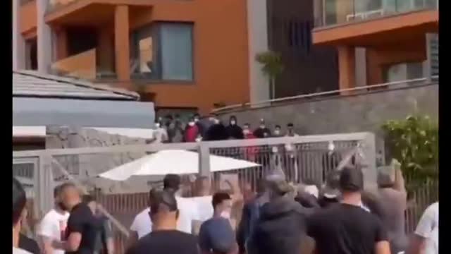 Following an assault, a group of angry Spaniards try to enter a hotel occupied by migrants