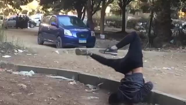 Teen in grey shirt black pants tries to do front flip ends up faceplanting