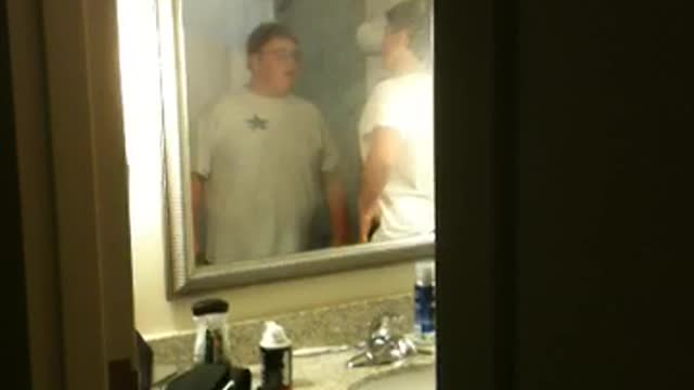 Fat guy in white shirt arguing with skinny guy in white shirt for dibs for shower