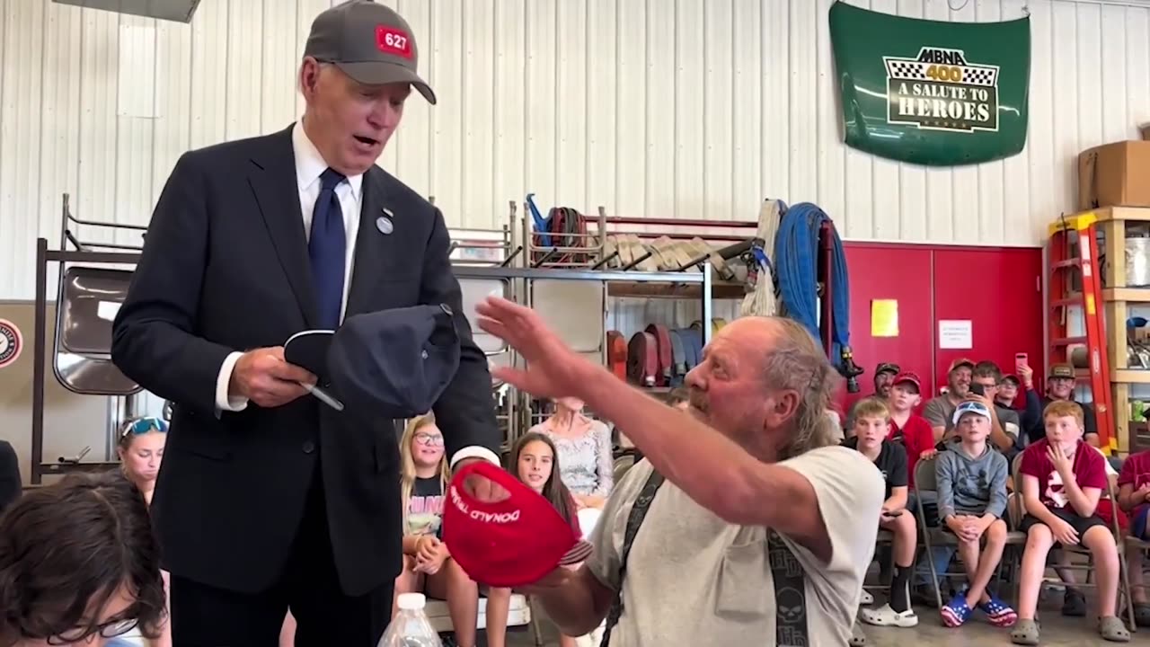 Biden’s Trump hat gesture win cheers from crowd