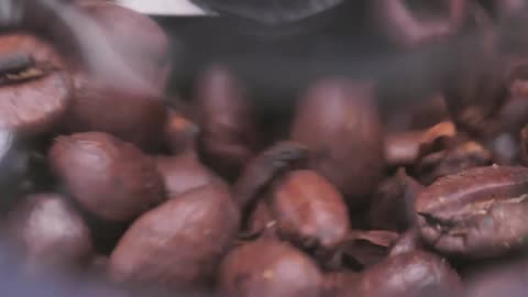 Roasted coffee beans in a grinder