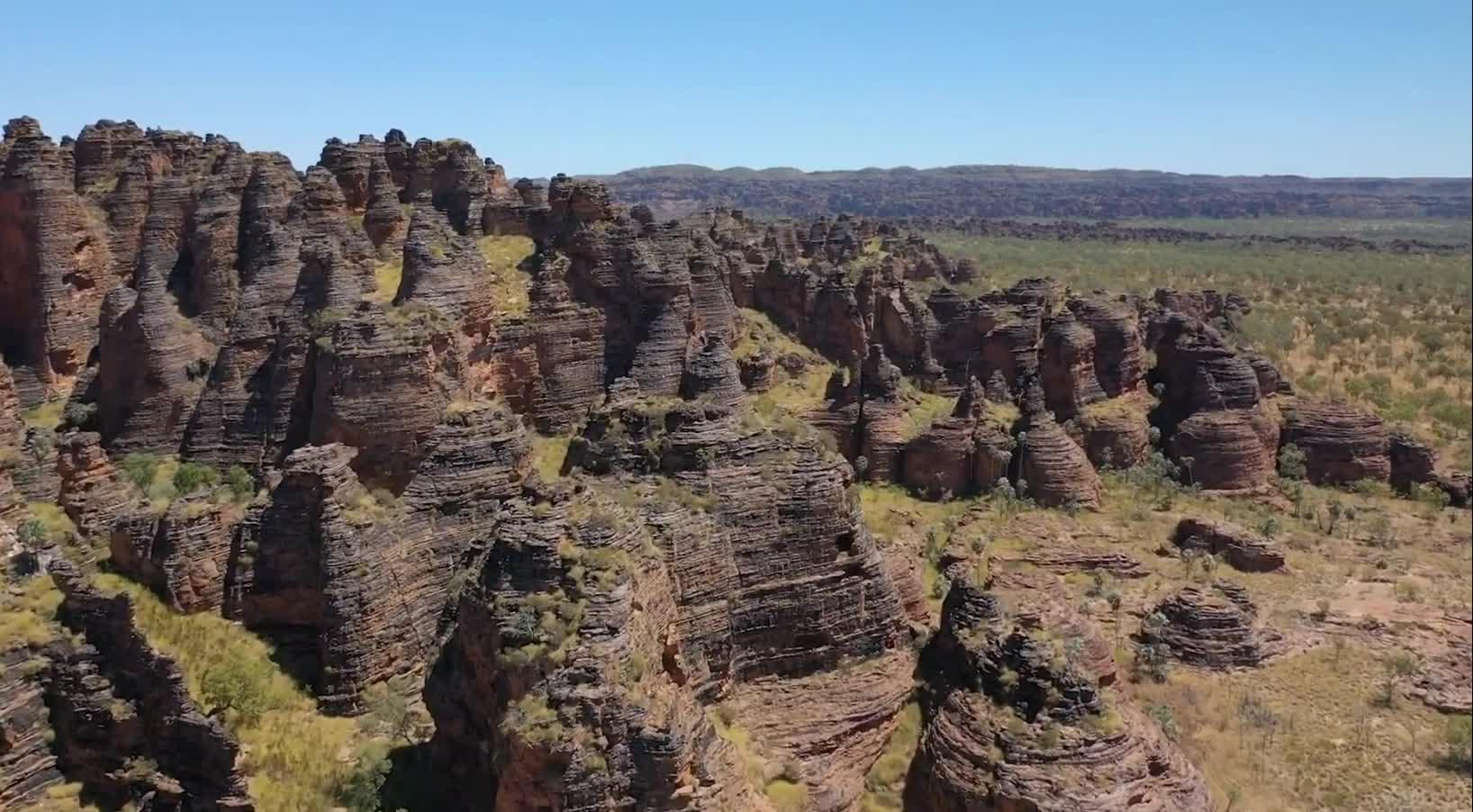 The geologists ignored the heat of burning sand and crumbling rocks