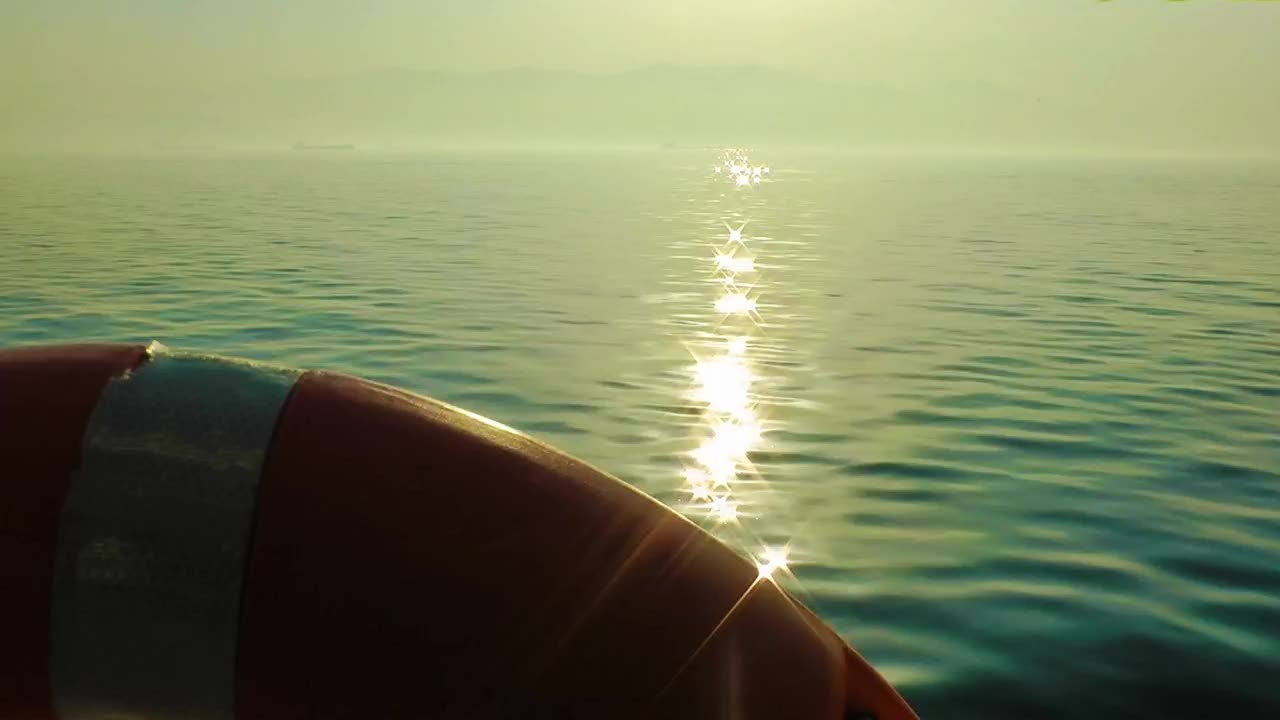 Sun light reflected in the sea seen from a boat