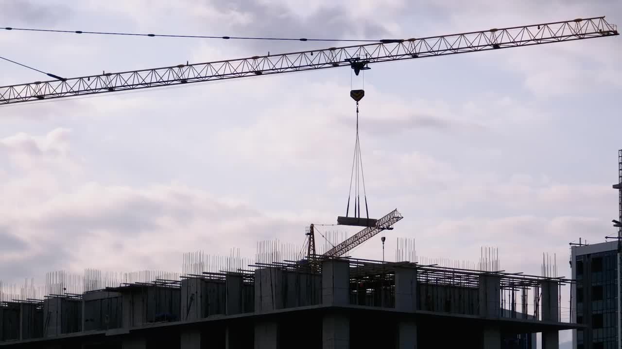 Tower crane with load on a construction site