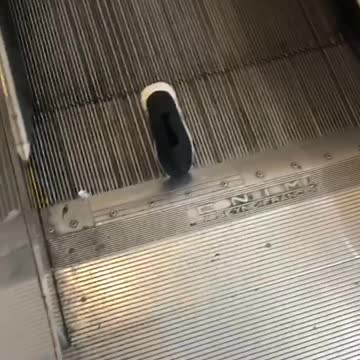 Woman gets her old pair of shoes stuck on an escalator after buying new pairs from nike store