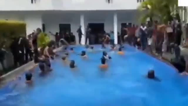 Sri Lankan protesters after storming the President house are swimming in president’s pool