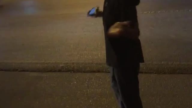 Guy standing in street with headphones in almost gets hit by black van