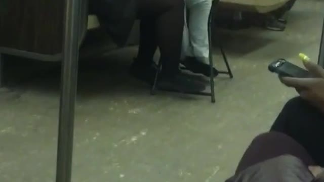 Woman sets up small dining table on subway train