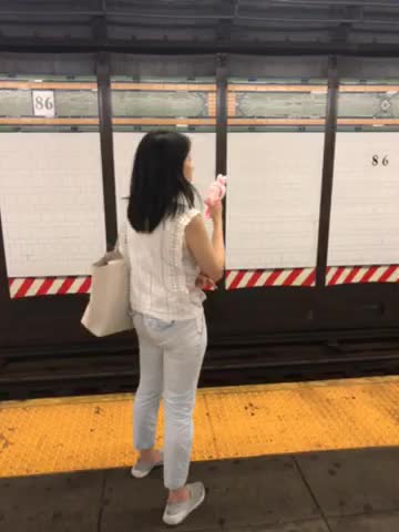 Woman spraying herself with water and air